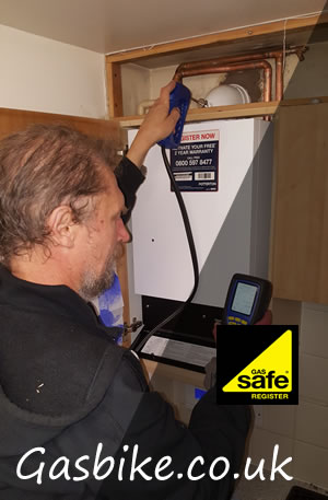 engineer checking the combustion readings of a boiler